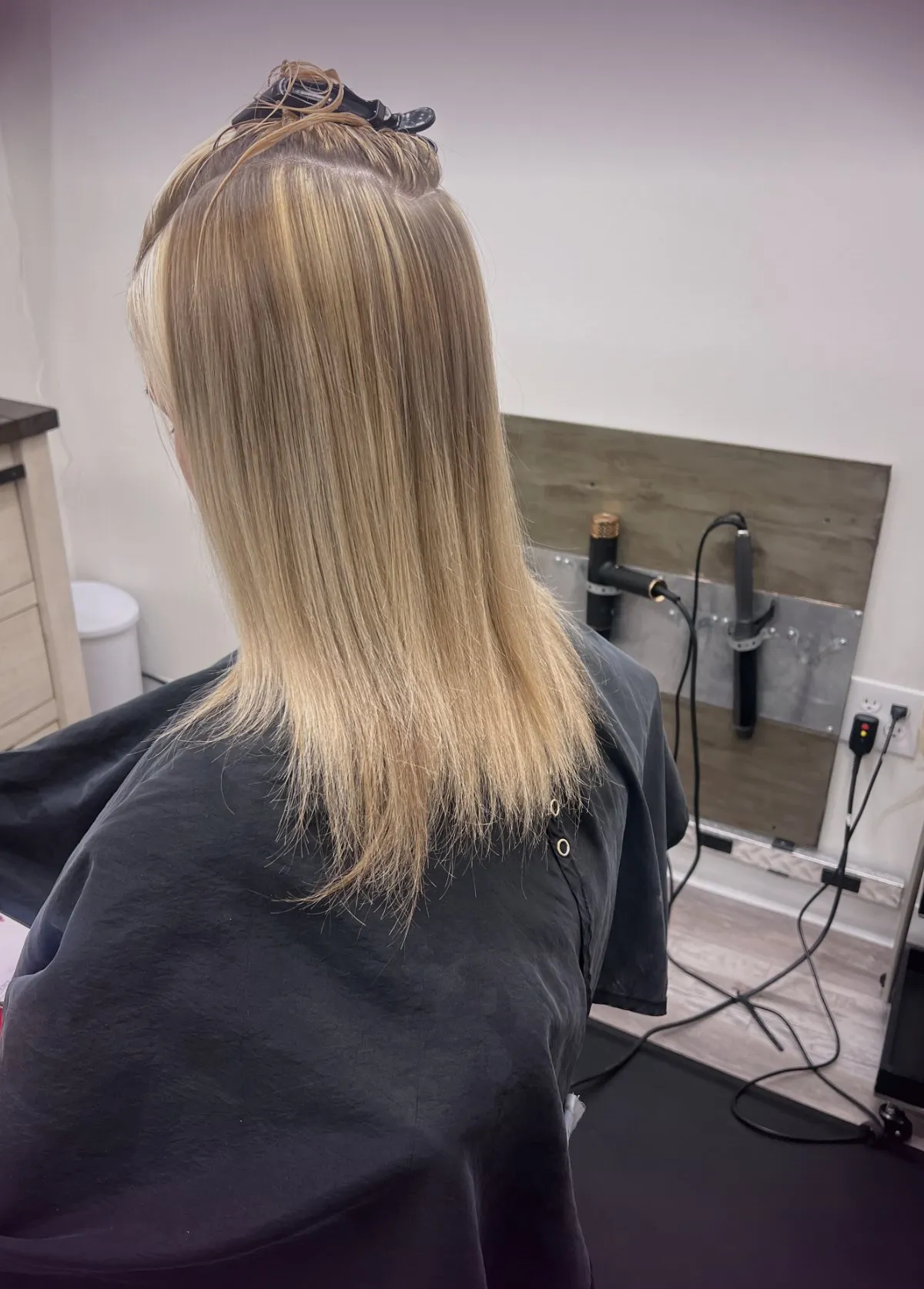 Before a tape-in hair extension appointment, showing the client’s natural length and density